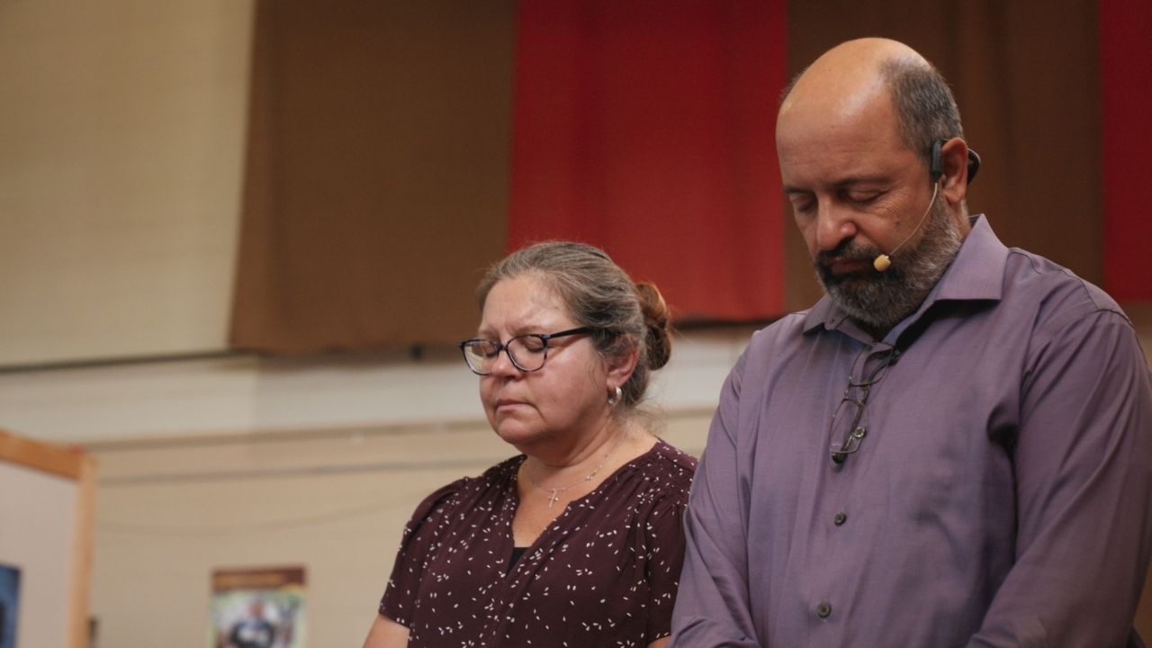 a woman and man praying together